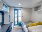 Private en-suite room with bed, desk, and storage at Riverside Quay