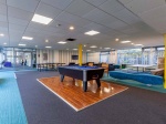 Communal living area with seating and TV, pool table at Polhill Park